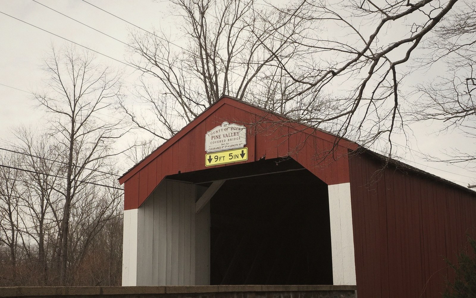 Pine Valley covered bridge entrance with a height clearance sign reading 9 feet 5 inches